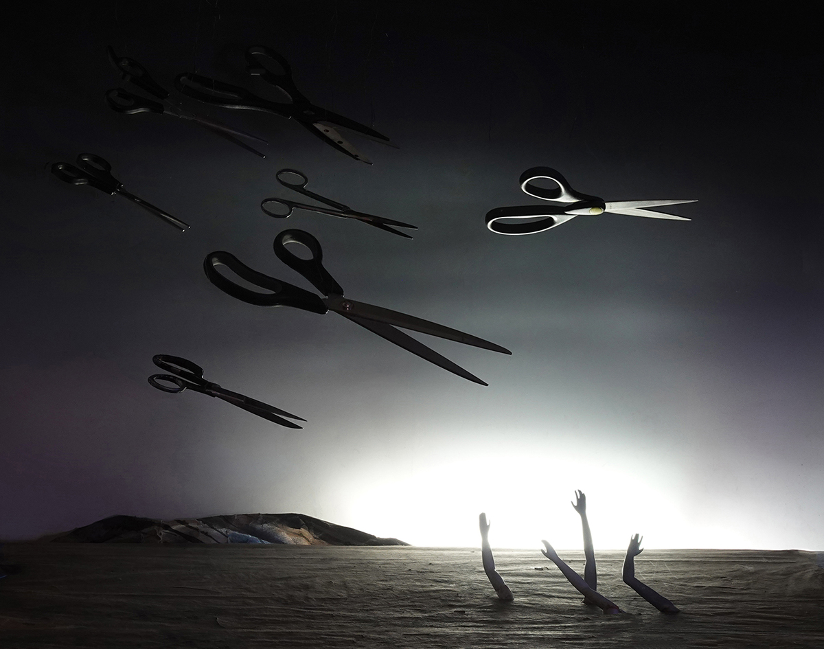 scissors, flying scissors, surrealism, surreal landscape photography, threatening, menacing, symbolism, political commentary, arms, womens' arms, caling for help, threatened by cuts